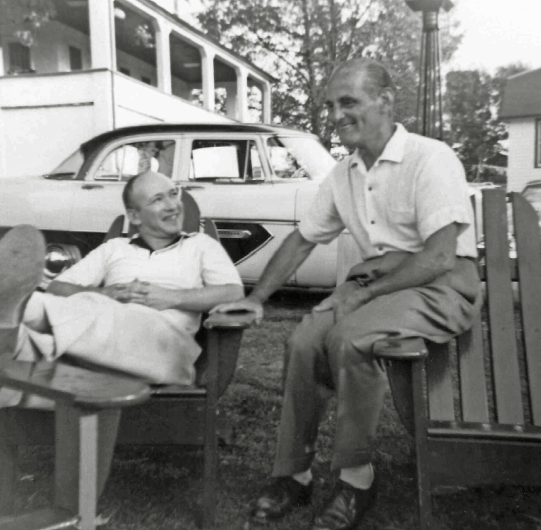 My father (left) chats with his brother-in-law Abe, who was the husband of his oldest sister, in a set of Adirondack chairs, blocking full view of a perfectly lovely, two-tone, 1956 Plymouth Belvedere. I haven’t a clue who owned the Plymouth. We had a 1952 Studebaker at that time. Abe lived in a New York City apartment that had no place to park a car. Location is probably some Catskills resort hotel. Date is late 1950's.

