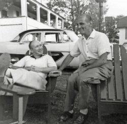 My father (left) chats with his brother-in-law Abe, who was the husband of his oldest sister, in a set of Adirondack chairs, blocking full view of a perfectly lovely, two-tone, 1956 Plymouth Belvedere. I haven’t a clue who owned the Plymouth. We had a 1952 Studebaker at that time. Abe lived in a New York City apartment that had no place to park a car. Location is probably some Catskills resort hotel. Date is late 1950's.
(ShorpyBlog, Member Gallery)