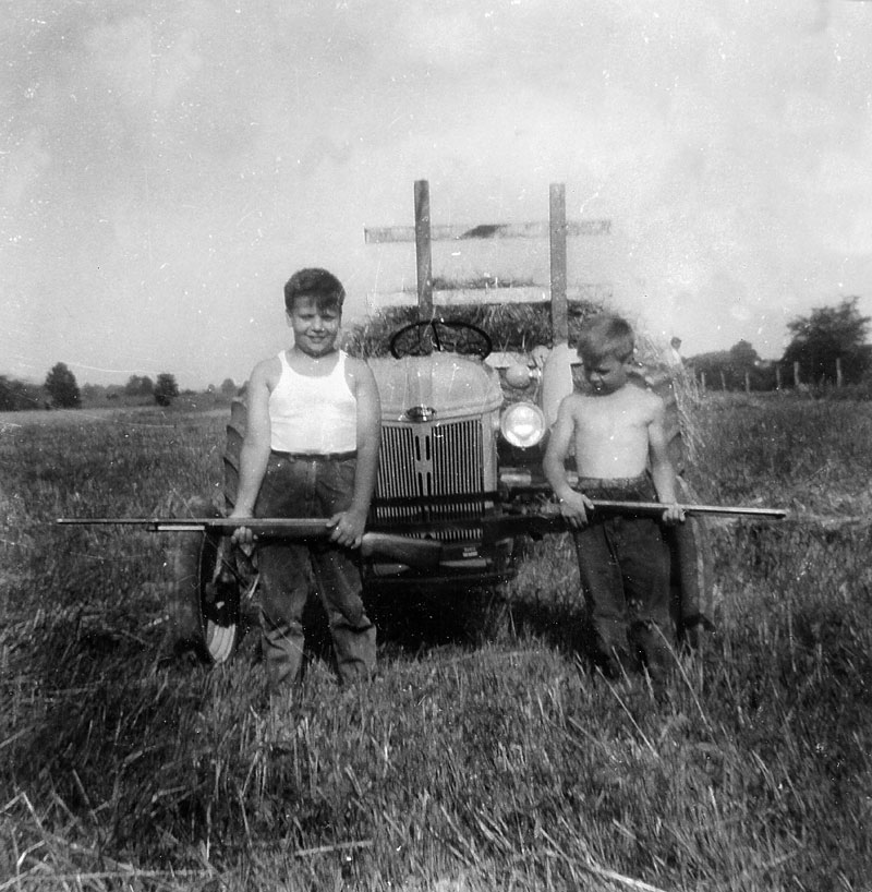 My Dad's cousins at our farm in St. Martin, Ohio (just outside Cincinnati). This was the big summer getaway place for the family after my grandfather bought it in the late '30s.  Every boy should learn his way around a shotgun . . . and a tractor! View full size.