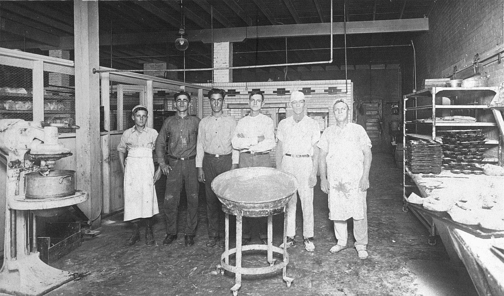 The Biloxi Bakery workers of 1913 - the founder, Fred Klein Sr. is in the middle - arms folded.  Famed for his New Orleans style french bread, he operated the bakery until his retirement in 1964.  His three sons operated the bakery until 1973 when it was demolished to make way for an urban renewal project - that subsequently failed! No air conditioning, no overhead lighting (except for the gas mantle globed lamps), just lots of flour!