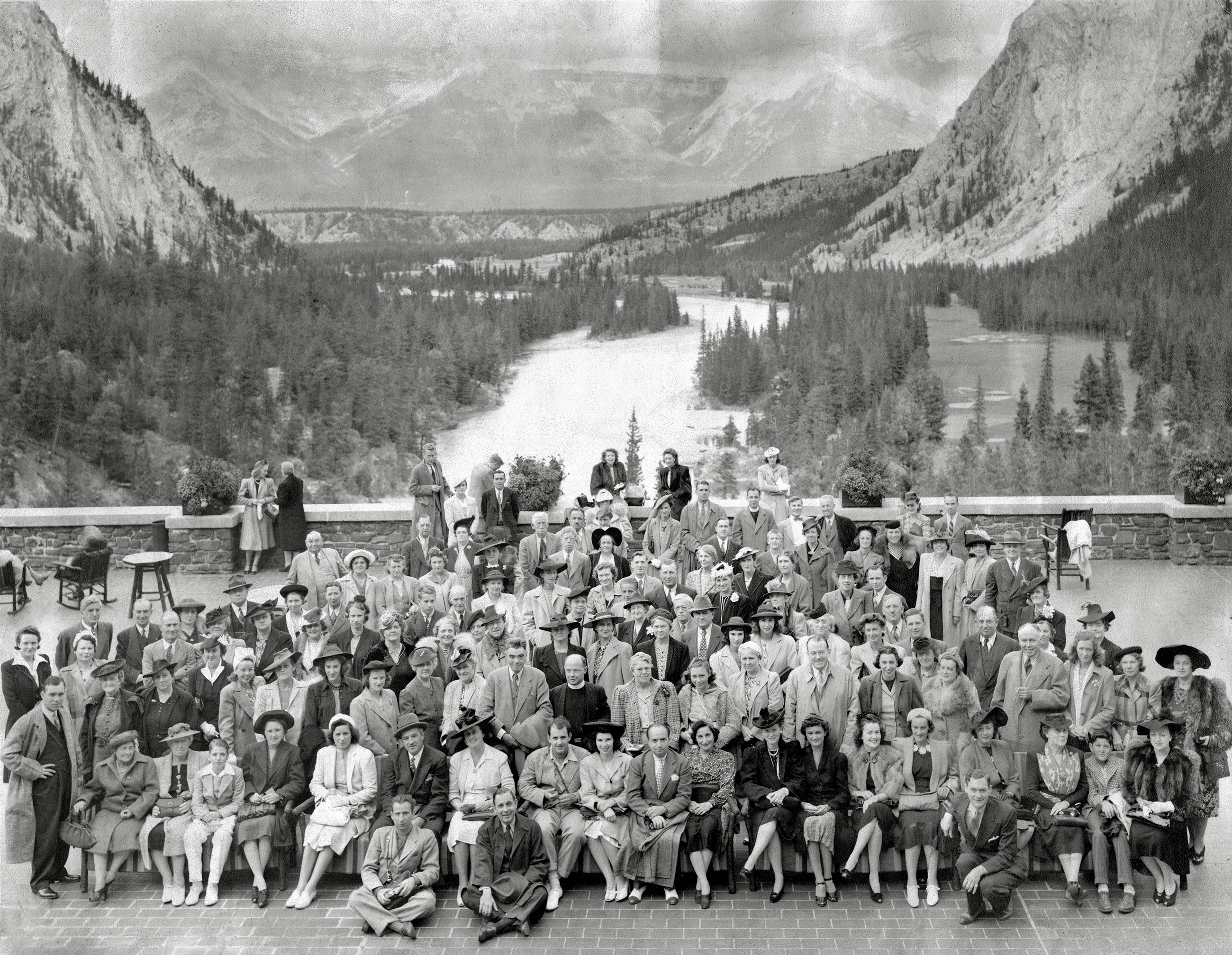 Photo stamped on back "Photograph by Associated Screen News Limited, Banff Springs Hotel, Banff, Alberta" with a handwritten "Sept. 1941" above. Original print measures 13 1/2 x 10 3/4 inches, with a hard-to-scan matte finish.

I did some minor digital cleaning (dust and creases) and converted from faded sepia to grey for better contrast. Found at a Northeast Ohio flea market in a box of old pictures and purchased for $1. It was simply an interesting pre-war photo with great scenery, people, and clothing; take special note of the John C. Reilly -like mug front and center. I bet he was a character! View full size.