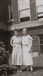 This is a photo of my great grandmother Bertha Mason (right).  The caption on the back of the photo indicates it was taken in the 1930s at the Franklin Street School in Grand Rapids, Michigan, where she was the principal.    
Bertha’s December 1945 obituary indicates she was a “former principal of several public schools in Grand Rapids.”  This includes the Franklin St. School, Lafayette Avenue School, and the South Division Avenue School.
The Franklin St. School building is still standing, but has been renamed the “Southwest Community Campus.”  It remains part of Grand Rapids Public Schools.  Using Google Maps Street View, I found the exact place this photo was taken, which pleased me greatly. View full size.
(ShorpyBlog, Member Gallery)