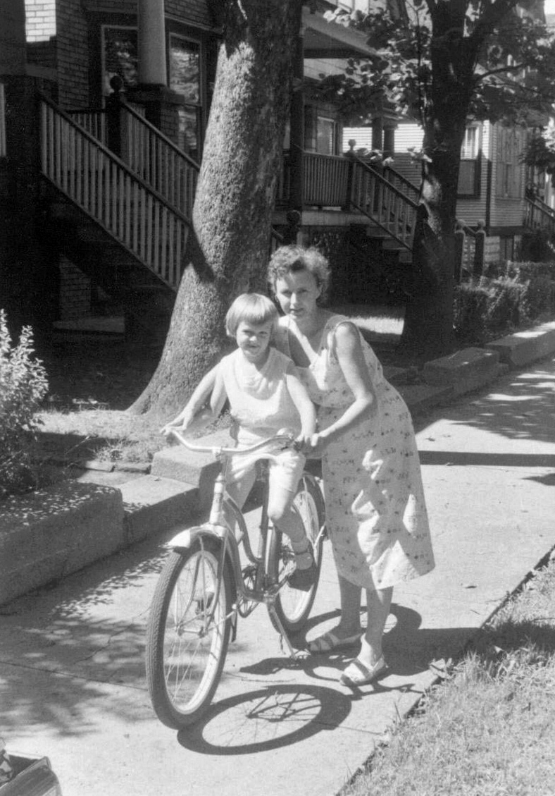 Chicago, IL, circa 1956 - a very hot summer. This is a photo of me (on the bike) and my mom, Ona Kolis (nee Rackauskas). My name is Janine.   My parents immigrated to Chicago, separately, after WWII, met while working at the Hart, Schaffner and Marx clothing factory and married.  We lived on the south side of Chicago, near St. Bernar's parish (near 67th and Bishop Street). View full size.
