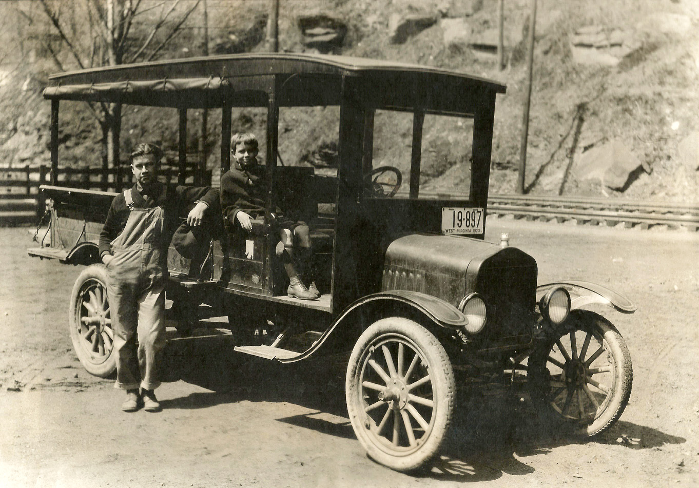 My wife's grandfather, John William Hicks Mitchell, a delivery man for Austin's Grocery in Northfork, McDowell County, West Virginia, in 1923. He moved to Northfork from Elk Creek, Virginia in hopes of finding work. Prior to the store owner's purchase of this truck, Bill delivered groceries by horse and wagon. "Bill" Mitchell was 20 years old in this picture; the young boy shown with him is unknown to our family. I was fortunate to have known Bill well for many years, after marrying his granddaughter in 1985. Bill passed away just shy of his 90th birthday in 1993. View full size.