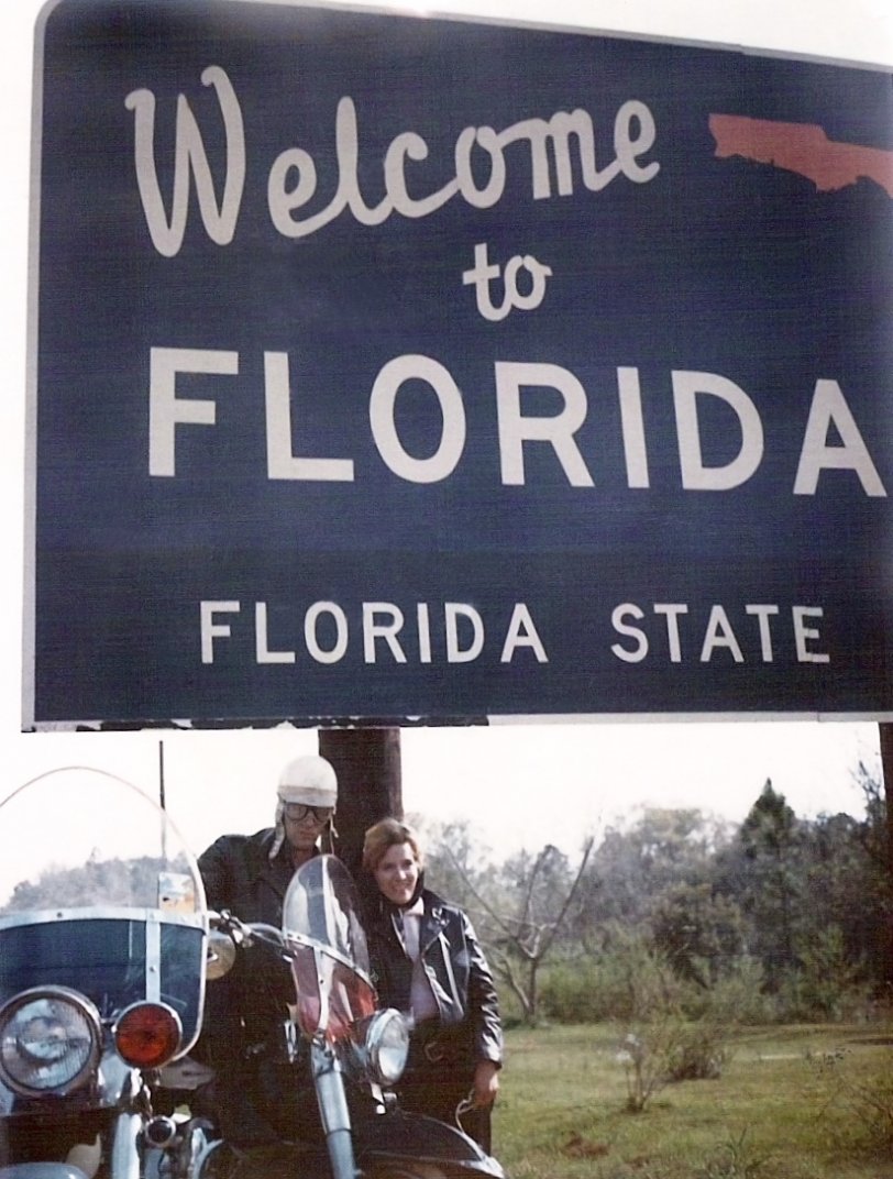 This is a photo of my mom and dad in 1963. I believe my dad was riding a 51 Harley. My mom's twin sister and her husband were also on the trip and the other bike in the photo belonged to them. They were riding from Birmingham, Alabama and here they are at the state line. View full size.
