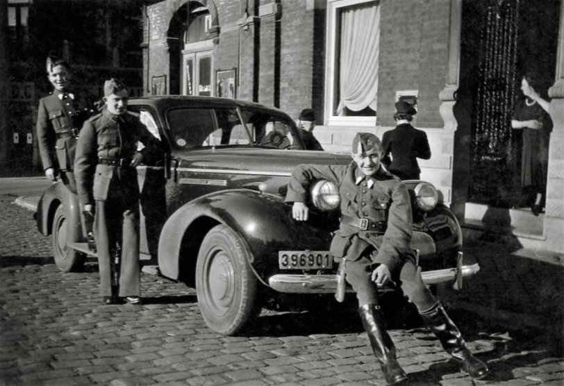 Here is a picture of my grandfather taken in Binche (Belgium) in 1940. He's the one sitting on the front bumper of this 1939 Buick Special, with two of his friends behind. He was 19 at the time, and they had just been called to join the Belgian army, as dark clouds were quickly approaching.
The 1939 Buick Special was owned by a local wealthy taylor in Binche, which was at the time a thriving city specialized in clothes manufacturing. At the time, an American car was quite rare and a sure sign of wealthiness.
The Belgian army was defeated in 18 days, and my grandfather and his comrades fled to southern France. He almost went to England to continue the fight, but happened to be less than 30 miles from his fiancée, my future grandmother. So they went back together in Belgium, and went through the war unarmed, although he was regularly sought by the Germans to go and work in Germany. View full size.
