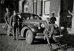 Here is a picture of my grandfather taken in Binche (Belgium) in 1940. He's the one sitting on the front bumper of this 1939 Buick Special, with two of his friends behind. He was 19 at the time, and they had just been called to join the Belgian army, as dark clouds were quickly approaching.
The 1939 Buick Special was owned by a local wealthy taylor in Binche, which was at the time a thriving city specialized in clothes manufacturing. At the time, an American car was quite rare and a sure sign of wealthiness.
The Belgian army was defeated in 18 days, and my grandfather and his comrades fled to southern France. He almost went to England to continue the fight, but happened to be less than 30 miles from his fiancée, my future grandmother. So they went back together in Belgium, and went through the war unarmed, although he was regularly sought by the Germans to go and work in Germany. View full size.
Still special after all those yearsSome additional information coming directly from my grandfather (he's almost 94 now but still very young at heart).
The guy standing in the back is actually the son of the tailor who owned the Buick. I guess that's why he was allowed to stand on the running board !
The picture was taken while they were on leave.
(ShorpyBlog, Member Gallery)