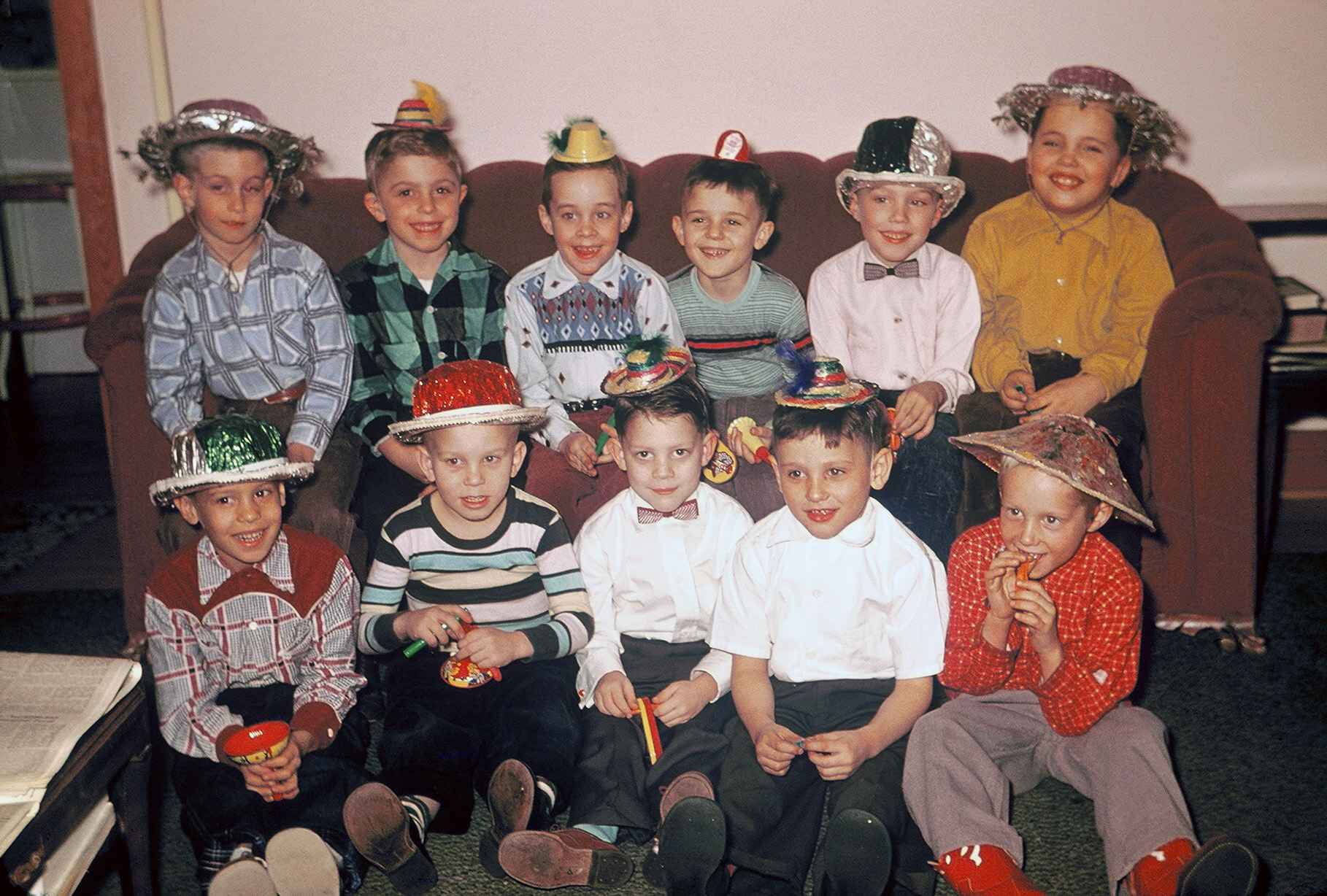 Pennsylvania circa 1956. A birthday party for my older brother, lower right in the red cowboy boots. He looks to be turning 6 or 7, which would make this near the end of January 1956 or 1957. My mother served spaghetti because it was his favorite meal. Today she'll tell you that she must have been out of her mind to serve spaghetti to all those boys. There were no expensive "thanks for coming" goody-bags like kids get today. They were given a couple of noisemakers (which, knowing my mother, were left over from New Year's) and sent home to drive their parents crazy! View full size.