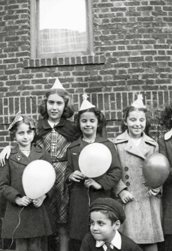 Location is Brooklyn New York City. The event is a birthday party that my approximately eight year old future mother, Arlene  (in the light coat) attended. 
It was supposed to be a picture of the girls at the party, but somebody’s little brother snuck into the frame.
The coat my mother is wearing might have been a  coat her father made for her. He made at least one of her childhood winter coats.
