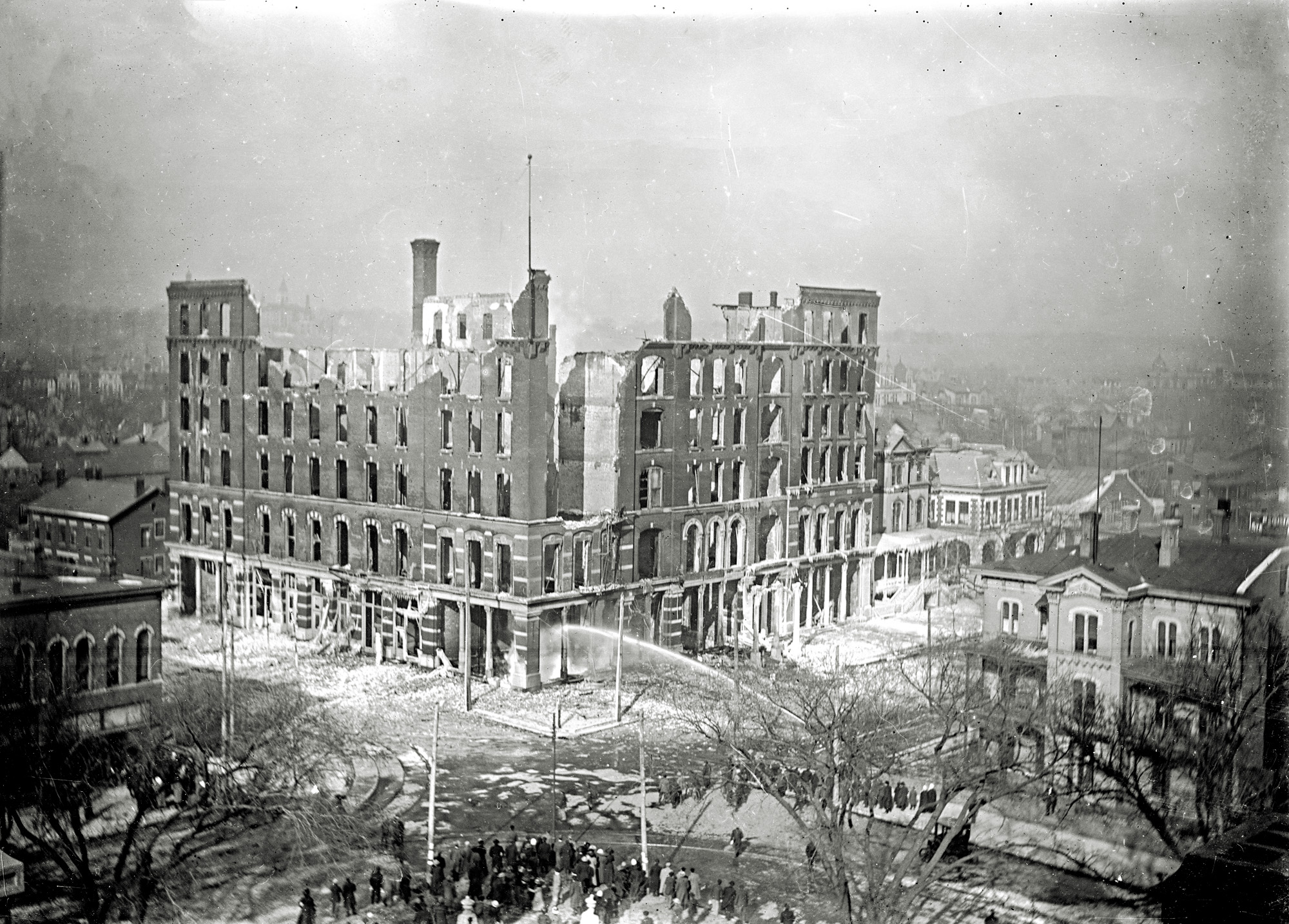 The National Hotel Fire (corner of Hamilton and Jefferson Streets), Nov. 12, 1911. Opening on October 30, 1883, the National quickly became the preeminent elegant Hotel in Peoria, until its untimely demise. Firefighter Chester Mooberry of the Peoria Fire Department died in the line of duty when he was caught beneath a falling smokestack. (Permission granted and courtesy of Peoria Historical Society Collections) View full size.