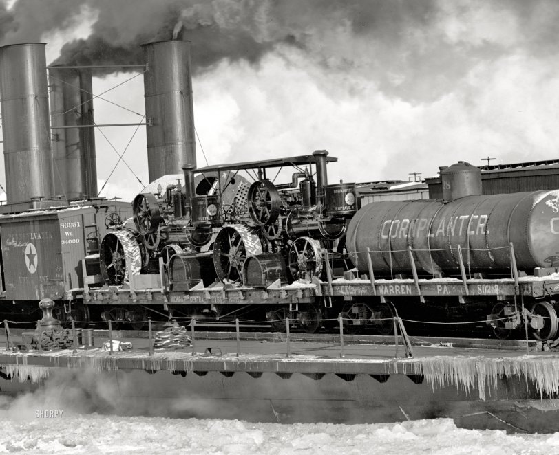 There probably aren't many photos out there of a steam tractor on a railcar on a boat on ice. Here we see two brand-new Buffalo-Pitts steam tractors on a flatcar aboard the transfer steamer City of Detroit on the Detroit River in winter. 8x10 inch dry plate glass negative, Detroit Publishing Company. View full size.
