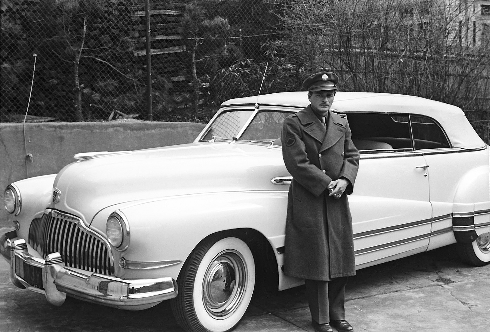 U.S. GI with his Buick Eight convertible; plate has 1943 as the date. From a set of found negatives. View full size.