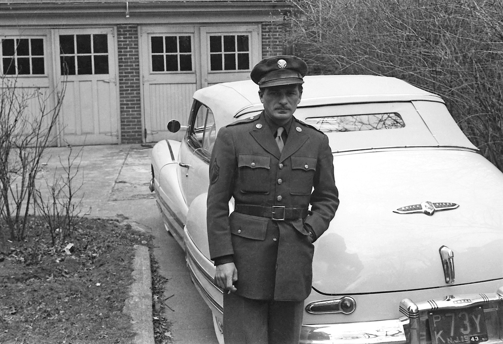 U.S. GI with his Buick Eight convertible; plate has 1943 as the year. From a set of found negatives. View full size.