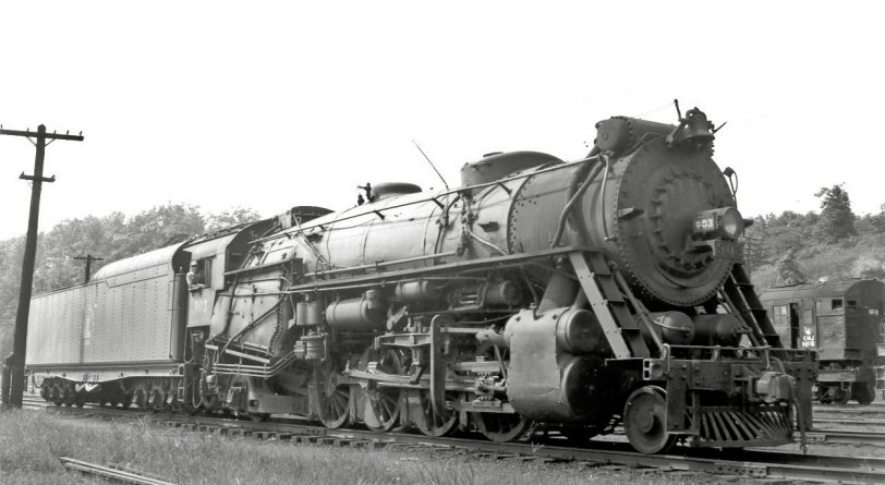 Another from the large-format steam library.  Central Railroad of New Jersey 903 (ALCO 1923), photographed near the roundhouse at Bethlehem PA in 1948.  This Mikado type sports dual air reservoir tanks on the pilot and an oversized Wooten firebox needed for burning anthracite coal.  The large tender is not original equipment and only a few CNJ Mikados carried them; I have no idea where it came from.  Other railroads were known for ordering switch engines and the like with huge tenders that they would swap out with road power upon delivery.  CNJ ordered few if any locomotives after this one was purchased, so I think they might have ordered new tenders from a builder in later years or purchased larger ones from another railroad. View full size.
