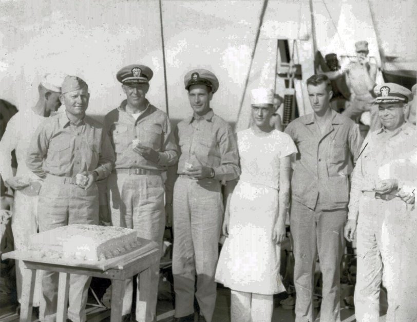That is a great looking cake. I don't know what they are celebrating, but it brought out the brass as well as enlisted folks. In the center is Chief Petty Officer James Watson, my wife's uncle, and this is one of his personal photos. During World War 2 he served on AP-76, the USS Anne Arundel, so this may be a celebration aboard that ship. The Arundel was a transport ship and saw service in the North Africa invasion, the Normandy invasion, and was in Tokyo Bay 10 days after the formal surrender. I have the cruise book for AP-76's wartime service, which was nothing like the experiences of Mr. Roberts, as well as a number of photos. View full size.
