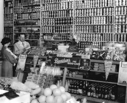 1940. Davidson's Bakery goods for sale in the cake display at Henry's (Harvey's?) grocery store in Olympia, Washington.