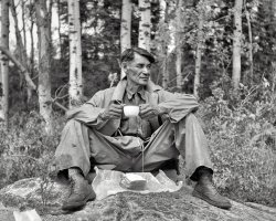 My grandfather took this with his Speed Graphic 4x5.  This was his and my dad's fishing guide eating his lunch on the shores of Lake of the Woods, Ontario, Canada, circa 1952. View full size.