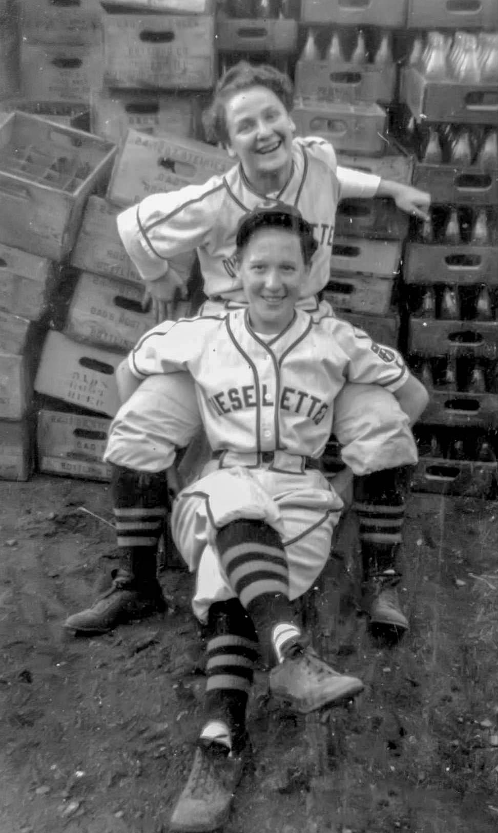 Mary "Max" Maxine (Schutt), pictured on bottom, and a teammate posing before a game among Coca Cola and other soft drink bottles, Peoria, Illinois, 1944.

The Caterpillar Dieselettes, from Mary Maxine's (Schutt) scrapbook. "Max" played from 1943 to '46. Also featured are Irene "Pepper" Kerwin and catcher Marian Kneer, pitcher Marie Wadlow, outfielder Carolyn Thome and second baseman Shirley Coney.

The Dieselettes are the oldest continuous softball team in America, playing since 1930. They were known as the Caterpillar Girls from 1930 to 1993, the Caterpillar Dieselettes from 1933-1955, the Sunnyland Lettes from 1956 to 1958, and became the current Pekin Lettes in 1959.