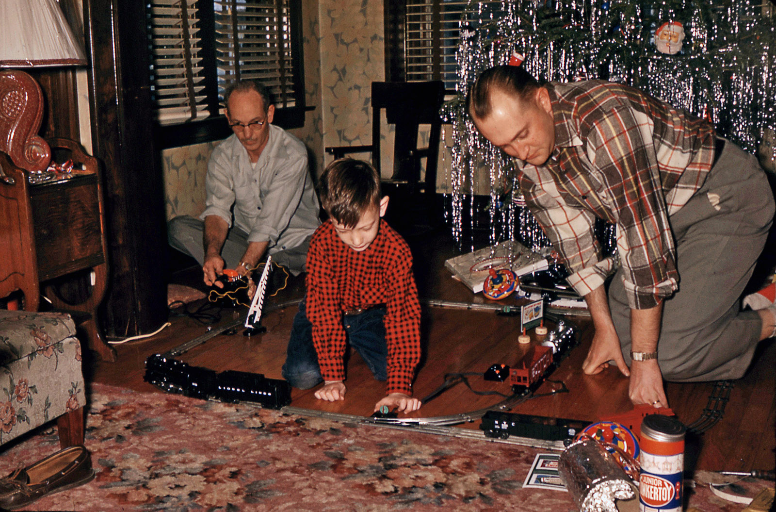 Christmas 1953. Oak Park, Illinois. My cousin Tom experiencing the thrill of his first Lionel electric train. My Uncle Bill is manning the transformer, and my dad, who was a real-life railroad engineer, is on the right. 35mm slide. View full size.
