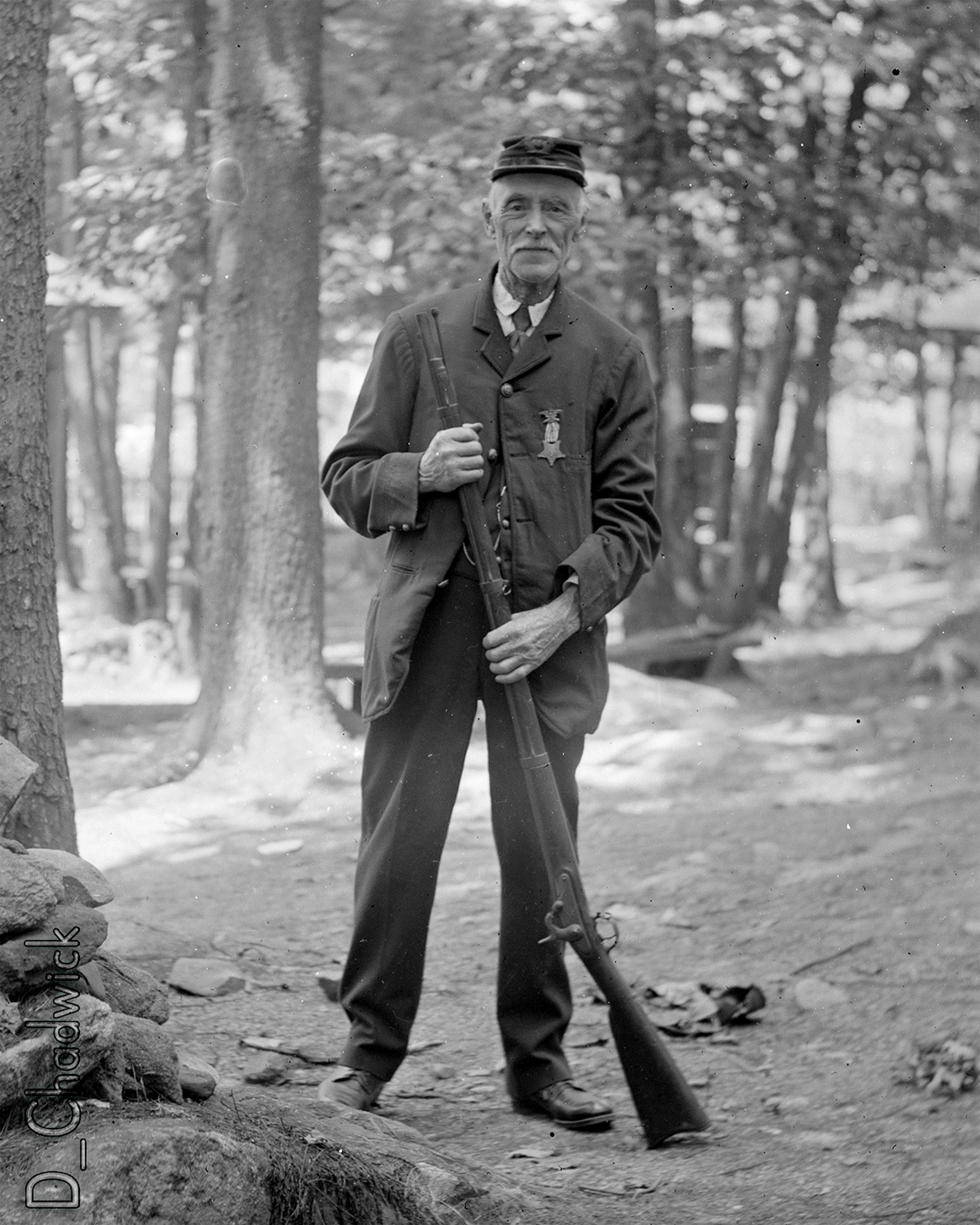 This came from Eastern upstate New York so from the 484 on his Kepi it’s my best guess he was a member of the Carlisle D. Beaumont GAR Post 484 in Keeseville, New York.  If anyone knows anything about that Post or the type of musket he’s holding could you let us know? Scanned from the original 4x5 inch glass negative. View full size.