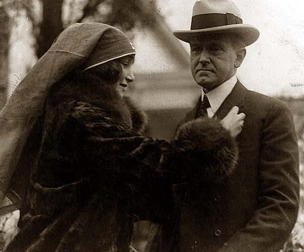 This photograph was taken in Washington, D.C., in 1926.  It features my maternal grandmother, Janet Whitton Moffett, with President Calvin Coolidge.  Ms. Moffett is pinning a medallion of some sort to Mr. Coolidge's chest, as part of a fund raising drive, perhaps to benefit the Red Cross.  Other photos of Janet Moffett (whom you refer to as "Jane Moffett") can be found on the Shorpy site.  Janet Moffett was the daughter of Admiral William Adger Moffett and Jeannette Whitton Moffett.  She married Elliott McFarlan Moore, and had three children, Janet, William, and Elliott McFarlan Moore.  After she was widowed, she married Griffith Mark, and had two sons, Griffith Mark and Peter Mark. View full size.