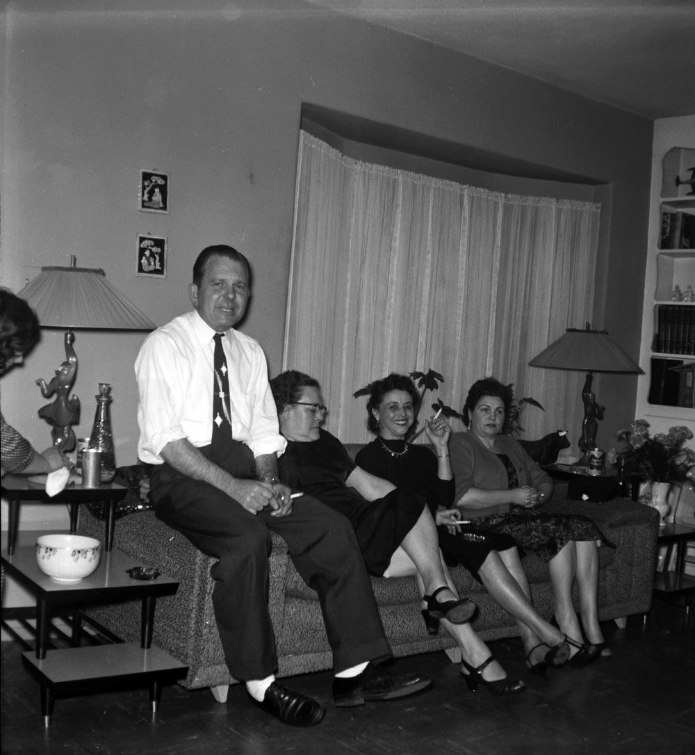 This is a snapshot from a party of some sort in the '50s. That's my grandmother sitting in the middle with her hand up. Scanned from a medium format safety negative. View full size.
