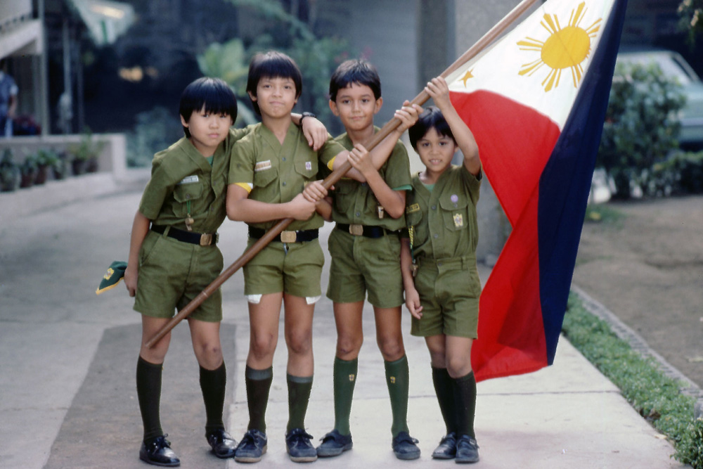 Visiting friends in Manila, Philippines I photographed their son "Cowboy" and his Scout friends for an impromptu group photo. I made this photo using a Nikon FM with a 105mm lens and 35mm Extachrome film. April 1983. View full size.