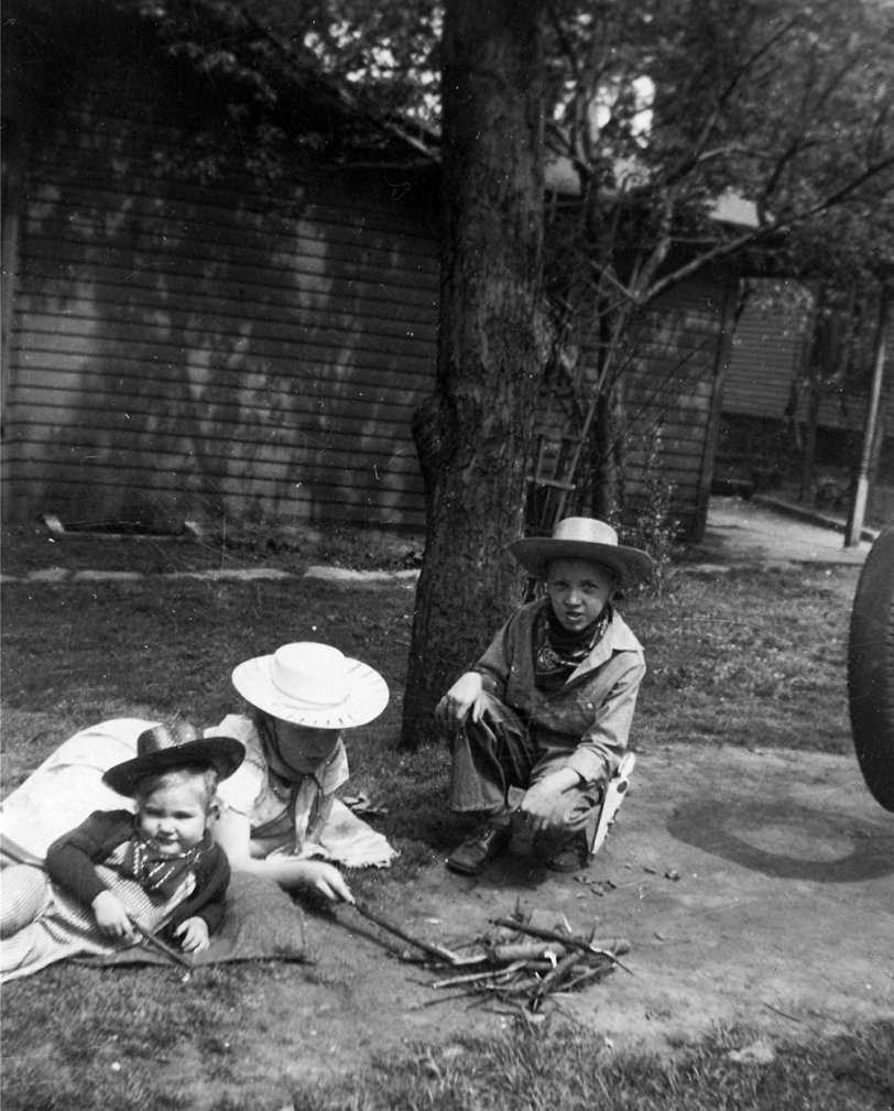 My sister, little cousin and I play cowboys in the yard on Washington Street, Freeport, Illinois, circa 1951. The house and trees are gone now. View full size.

