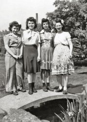 Cynthia, Arlene, Agnes, and Rosilyn is written on the margin of this photo showing my teenaged future mother (in the dark skirt) with three classmates, at some park or botanical garden in Brooklyn, New York near the end of World War II.
Please proposeHow I would love to know the location, and there are obvious clues for people who know Brooklyn.  So many more people view the main gallery than the member gallery (which is a shame, really -- hey, there're great photos every weekend, everybody), and that's why I'd like to ask the powers-that-be if they might consider, as is their practice, sometimes to elevate a post from the member to the main gallery, where many Brooklynites could identify the stack and the building.  I would consider that a very special Shorpy Christmas present, plus it would bring aenthal's mom Arlene to a deservedly wider audience.
At Prospect Park in BrooklynI asked my mother. She says the location in Brooklyn was Prospect Park.
(ShorpyBlog, Member Gallery)