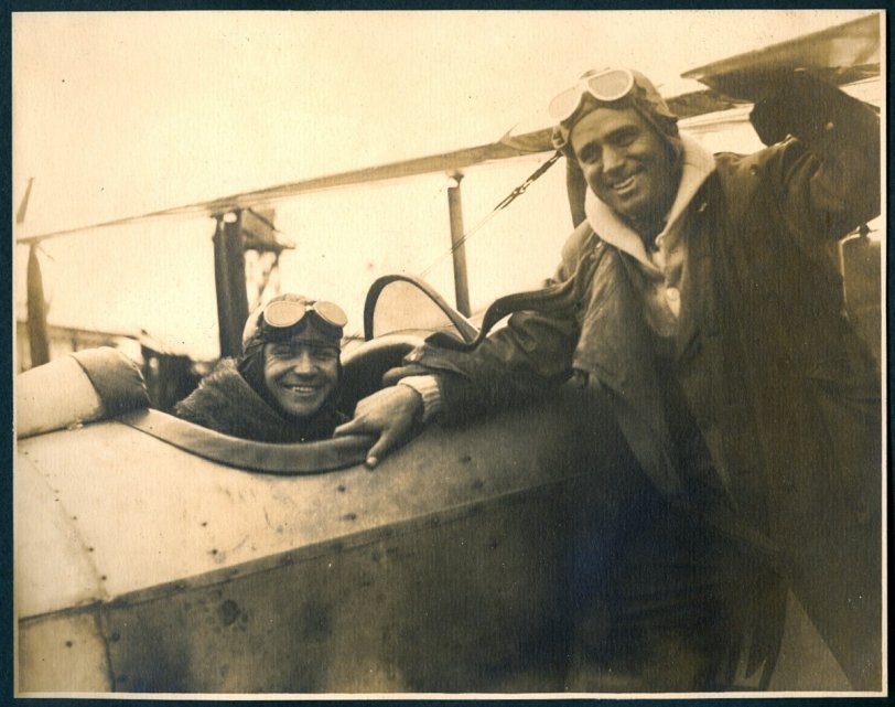 This photo is from one of our Grandfather's many photo albums.  This image shows pilot Bob Shank and actor Douglas Fairbanks.  Below is the caption from the album, circa 1917.
"Douglas Fairbanks agreed to raise $1,000,000 for the Red Cross in a week if the Post Office Department would send him by aerial mail to New York. Bob Shank brought him back with over $6,000,000 subscriptions." View full size.
