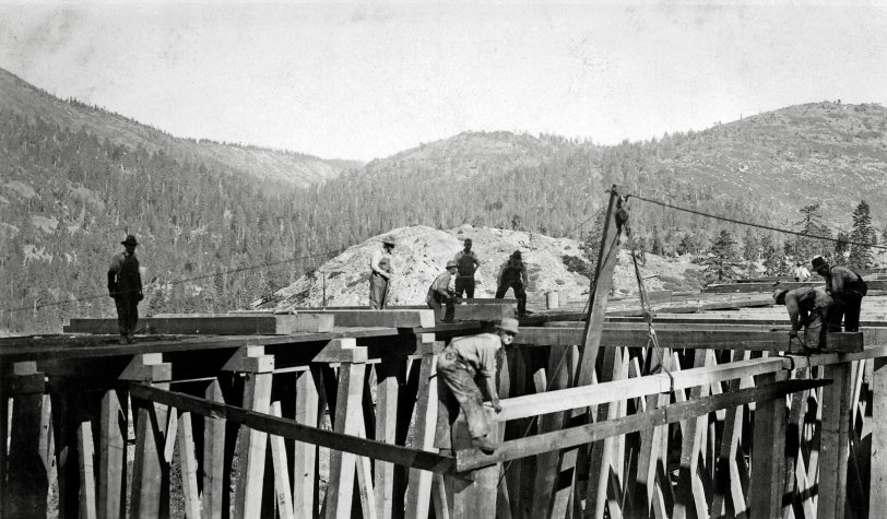 Southern Pacific maintained long stretches of wooden snow shed over its Donner Pass route in Placer and Nevada Counties, California. The sheds used an enormous amount of lumber and labor to construct and maintain and were beginning to be phased out in the 1930s except at key spots which the railroad deemed worth keeping.
Photo dates from the 1920s to 1930s and shows some construction or repair underway at Shed #10 which was located between SP's Crystal Lake and Cisco, Calif. stations. Norm Sayler Collection, Donner Summit Historical Society. View full size.

