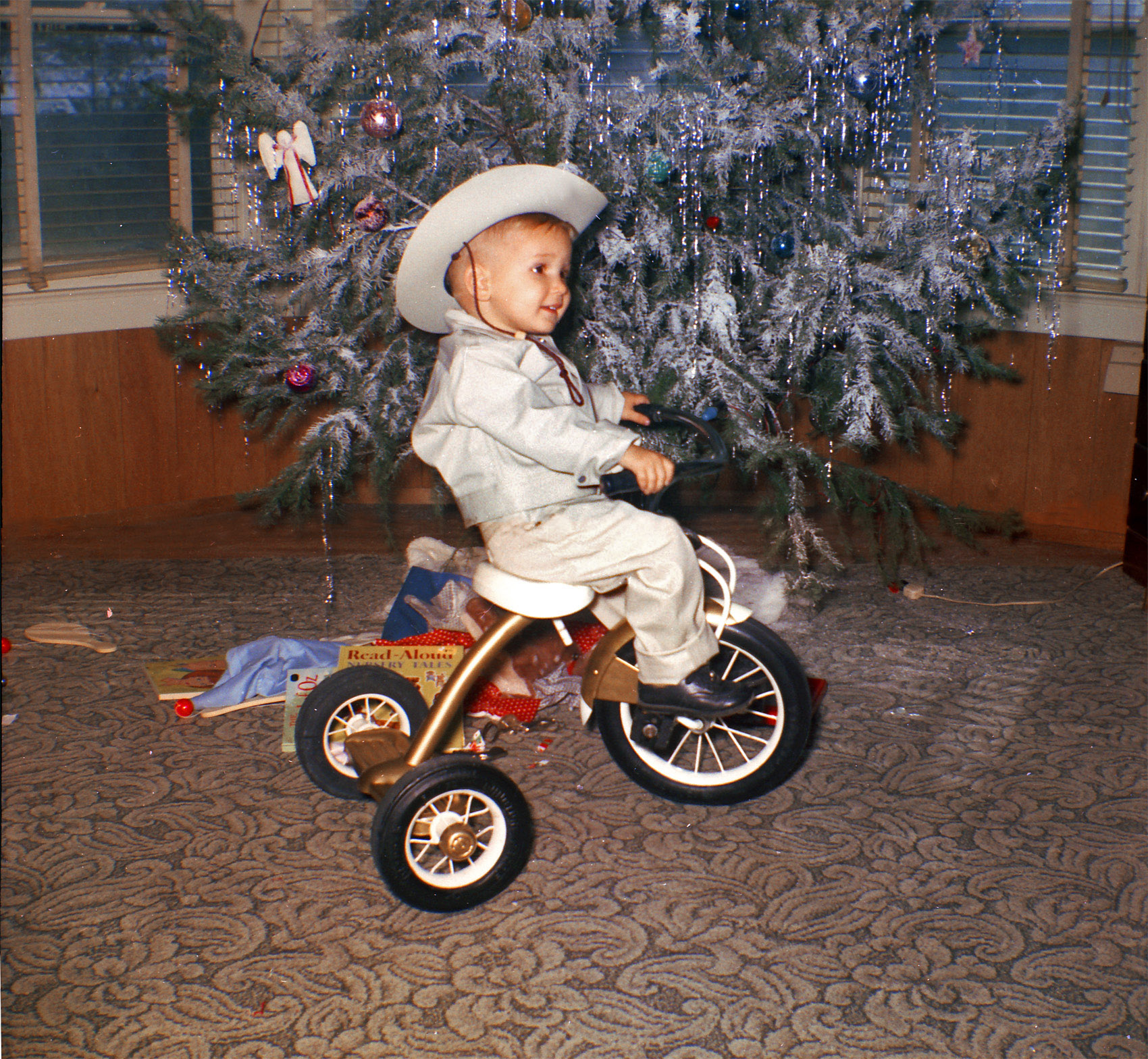 This picture of my dad was taken on Christmas Day, 1963. I thought it fitting to post this after seeing tterrace's tricycle picture. I guess the whole dressing up like a cowboy and riding tricycles thing was popular for a while. View full size.