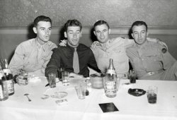 I love this one. This is my Dad's (on the left) first night on the town in the states after more than three years fighting with the 27th ID in the Pacific, around October 1945, near Seattle. He arrived in Washington state from Japan that day after being part of the first occupational forces. These guys are happy to be back! View full size.
Dad and his buddiesCazzorla's Dad and his buds are giving up a few details about themselves. Dad is an infantry lieutenant and has the Combat Infantry Badge and the Purple Heart. In 1947 all recipients of the CIB were retroactively awarded the Bronze Star Medal; many former infantrymen never got the word or were too busy creating new lives to care about it, but I hope your dad received his.
The man in the dark shirt has no insignia, but that is an officer's shirt. Next we have an officer from the Quartermaster Corps. On the right is what appears to be a captain in the Ordnance Corps; his ribbons are indistinct. His 27th Infantry Division patch is clearly visible; a New York National Guard division, the division participated in the invasions of the Gilbert Islands, Saipan, and Okinawa, then were part of the Occupation forces.
The Shasta Cola bottles, assortment of glasses, two ice buckets, and the packs of Camels and Luckies suggest they've been celebrating for a while. After what they went through they deserved a party.
(ShorpyBlog, Member Gallery)