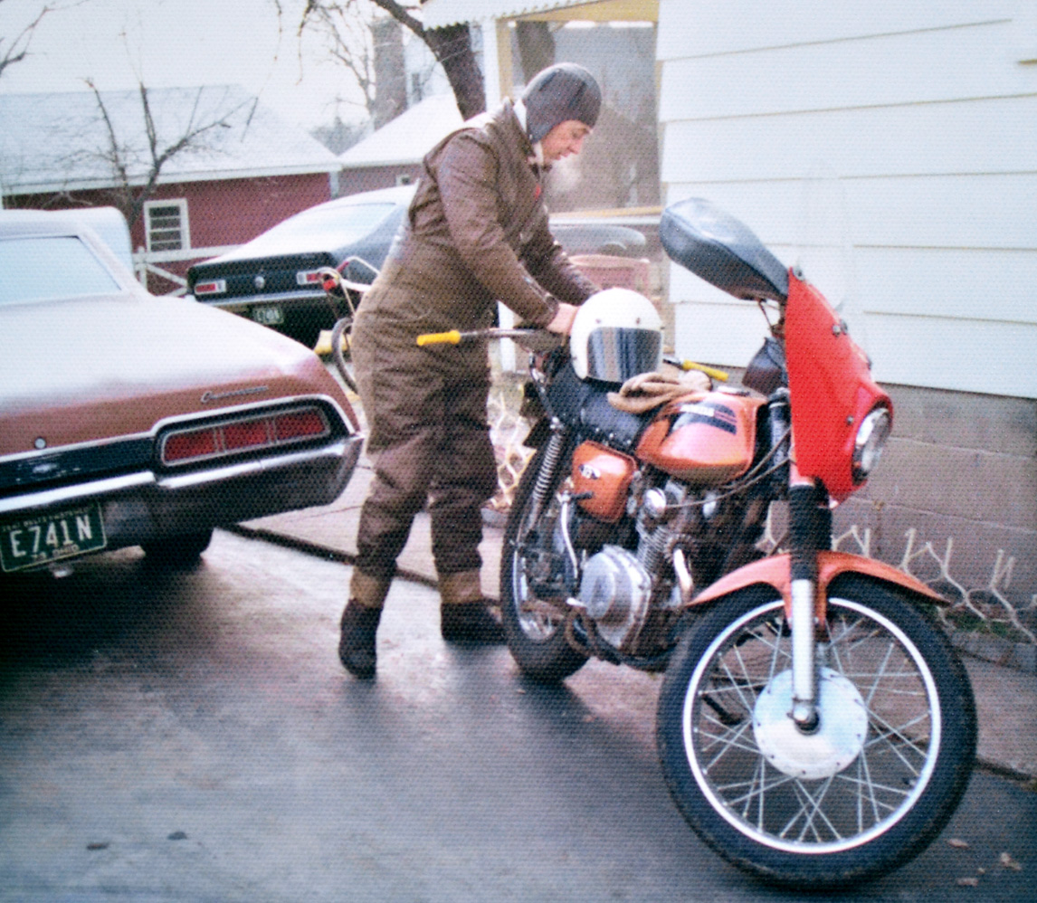 It must have been cold, he's all bundled up.   I think that bike was a 71 Honda CL175 Scrambler.  Around 1973 or 74 in Akron, Ohio. View full size.