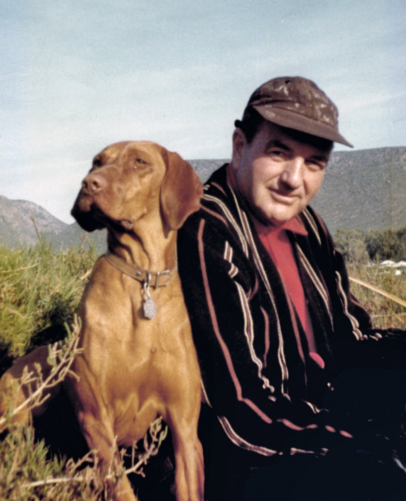 Here's my second Happy Birthday photo of my dad, taken by my mom during a quail hunting trip in Baja California in, I think, 1968. The wonderful dog leaning on him is Cefra, a Hungarian Vizsla. She was the smartest and most willing of the many dogs he had during his long life, and he just adored her. For those who might blanch at our old getaway pastime of hunting quail, my dad had a ready comeback: he'd explain that, unlike other forms of hunting, quail hunting in Baja meant a day of toiling up rocky hillsides through the cactus and eventually reaching the top, only to see the covey of quail flushing over the next ridge. But all through my childhood we had some swell picnics in what was then the unspoiled ranch country south of Ensenada.
