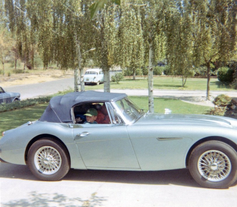 My father had long wanted a British sports car and in early 1968 he finally bought a new 1967 Austin Healey 3000. It was the last one sold at the dealership and I remember pulling out of the showroom the day he bought it. This is later that summer on our way home from our annual vacation to Fallen Leaf Lake near Tahoe. We had stopped at my grandfather's house in Sacramento for lunch and grandfather snapped this photo as we left for home in the Bay Area. That's me watching my side as dad backs the Healey out of the driveway. View full size.
