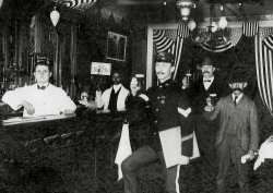 My father's Uncle, August Kappeler, born in Switzerland, who was a cavalry member of Teddy Roosevelt's Rough Riders.  Wonder what they were celebrating.  Don't have a clue as to the identities of the characters in the background or where the bar was. View full size.
Rough Riders ReunionYour Fathers Uncle appears to be wearing some sort of medal.
It is not a Medal of Honor as it has the wrong star orientation. It does bear a resemblance to a souvenir of the 1st Rough Rider Reunion, held in Las Vegas Nevada in 1899. Perhaps that is where they are.  
The other VegasThe Rough Rider Reunion of June 24-26, 1899 was held at the Plaza Hotel in Las Vegas, New Mexico.  The hotel is still there, although the modern bar doesn't seem to fit the picture above.  The other Vegas really didn't become anything until 1905 or so.
(ShorpyBlog, Member Gallery)