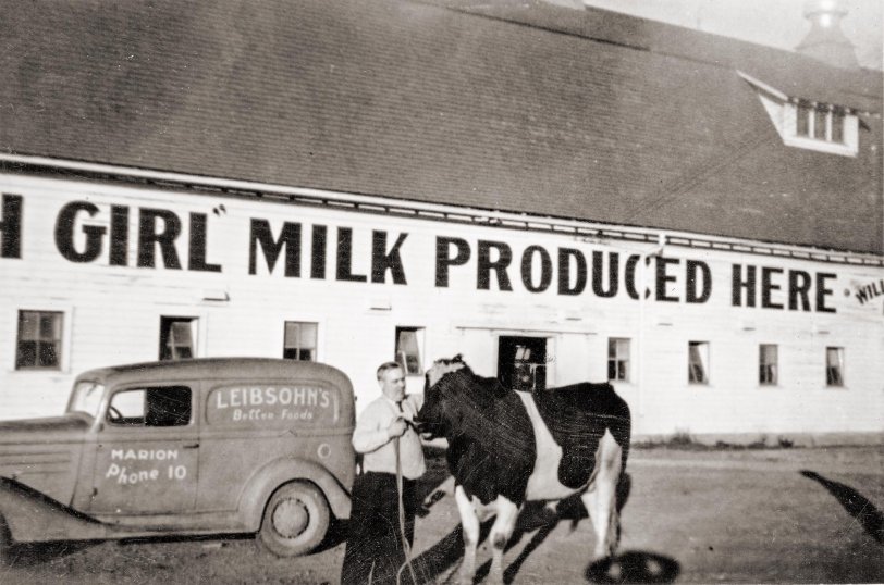 A Leibsohn grocery truck picking up milk at the Willard S. Haak Dairy Farm in Marion, Iowa, 1941.
