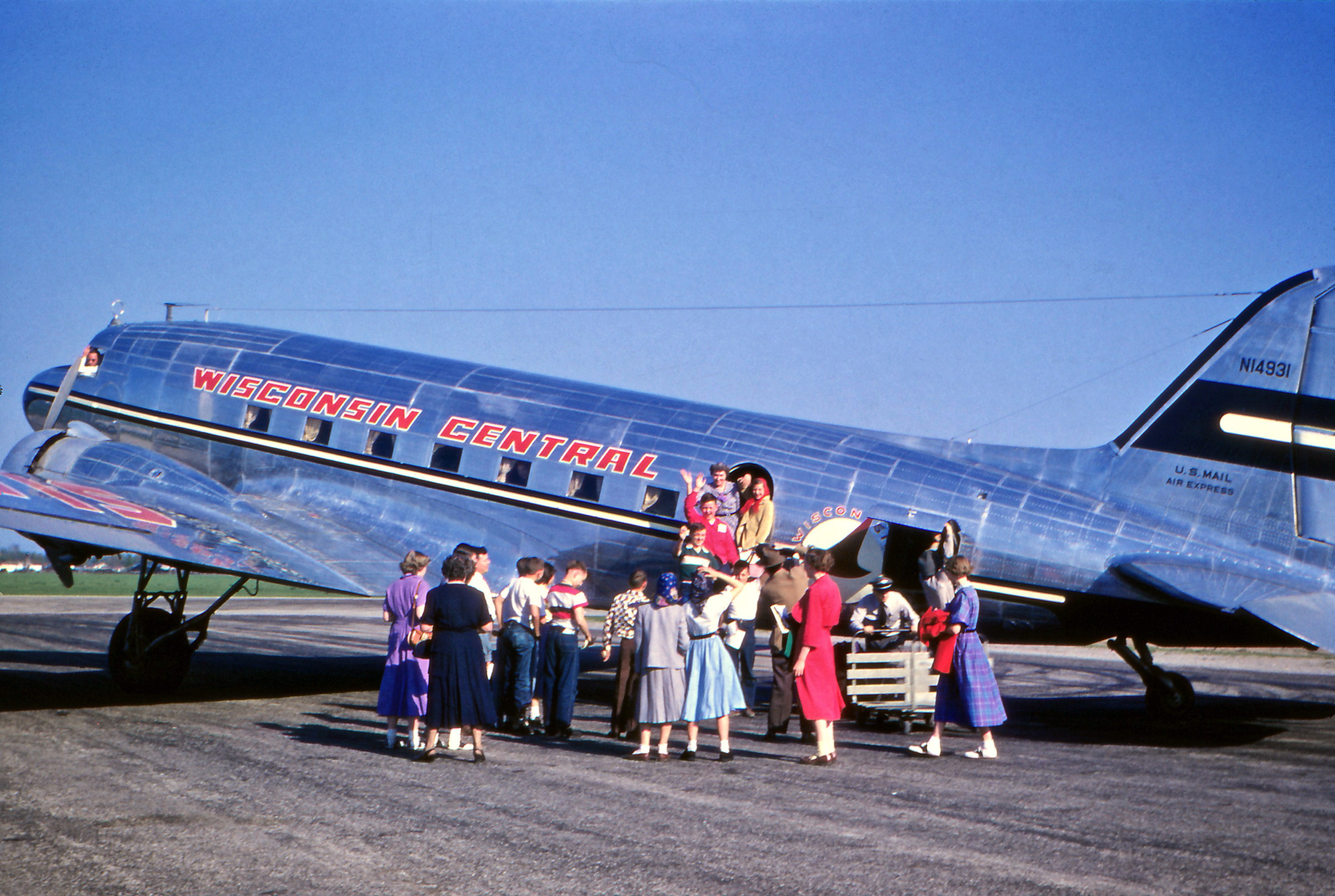 May 1952. Kodachrome by my great-uncle Herbert F. Krahn of Oshkosh, Wisconsin. I have no idea who any of the people are in this image, but I assume that someone on the plane flew into Oshkosh to visit Herbert and my great-aunt. Note that the pilot appears to be waving from the cockpit. View full size.