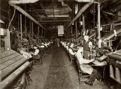 On close inspection, I see a McKinley political sign. So would that be just before the turn of the century? View full size.
&quot;Machine shop&quot;These are linotype operators in a newspaper pressroom.
1896The 45-star flag became official 4 July 1896.  Thomas Reed also ran for President in 1896 (losing the nomination to McKinley).  The 1896 Republican convention was in June, I would guess flag makers (and the linotype shop) got an early jump on the new flags.
[The flag in the photo has 44 stars, not 45. - Dave]
LinotypeIn the 1950s my Uncle George Percy Gaskill of Barnegat, New Jersey, was the plant manager for Sleeper Publications in Mount Holly. I visited several times to observe his operation of the Linotype there. It was used to cast molten lead into "slugs," one for each line of type ("linotype")in a newspaper column. I have a couple of inserts that he made for me with my name.
Thomas ReedI was curious why this shop displayed both primary candidates, which led me to wikipedia. But I was soon distracted on the political story when I saw this about Thomas Reed...
He was known for his acerbic wit (asked if his party might nominate him for President, he noted "They could do worse, and they probably will"; asked if he would attend the funeral of a political opponent, his response was "no — but I approve of it"). On another occasion, when a fellow congressmen declared that he would "rather be right than the president," Reed coolly replied that the congressman needn't worry, since he would never be either. His size -- over 6 feet in height and weight over 300 pounds -- was also a distinguishing factor. Reed was a member of the social circle that included intellectuals and politicians Sen. Henry Cabot Lodge, Theodore Roosevelt, Henry Adams, John Hay and Mark Twain.
Interesting and funny man with some notable acquaintances.
[Reed and McKinley weren't "primary candidates" -- state presidential preference primaries didn't exist in 1896. The two were contenders for the Republican nomination at the party's national convention. - Dave]
IntertypeIf you look at the man on the left, closest to the camera, just to left of his head is a shaft inside a large spring. This indicates the these machines were Intertypes a typesetting machine very similar and in someways superior to the Linotype. How do I know? I spent my apprenticeship operating linotypes, and later in Australia spent some time on Intertypes. The shaft was attached to a plunger that pumped molten typemetal that cast the lines of type or slugs.That machine room would have been very noisy!
Linotypes, not Intertypes.Sorry, these can't be Intertypes, as the first Intertypes weren't in production until 1917. 
Both Linotypes (some models, some years) and Intertypes had the vertically mounted spring for the pot plunger, it wasn't until much later that Lintotype moved that spring into the column. The actuation was slightly different as ll, as you can see on my 1922 Intertype.
From here:
"Original pot plunger spring on Linotype Model I was positioned directly above plunger lever to exert a straight downward action. Intertype continued this method as the patent must have run out by 1912. The Intertype spring pressure is released by simply unscrewing a rod straight up. Linotype "improved" their machine by a system of levers to put this spring inside the column. This worked until a stronger spring was necessary to cast larger slugs and improve faces for reproduction proofs. I remember a time in Santa Rosa, California, when it was a three-man job to put that heavy spring back in place on a Model 8 Linotype."
etaoin  shrdlu cmfwyp vbgkqj xz
(ShorpyBlog, Member Gallery)