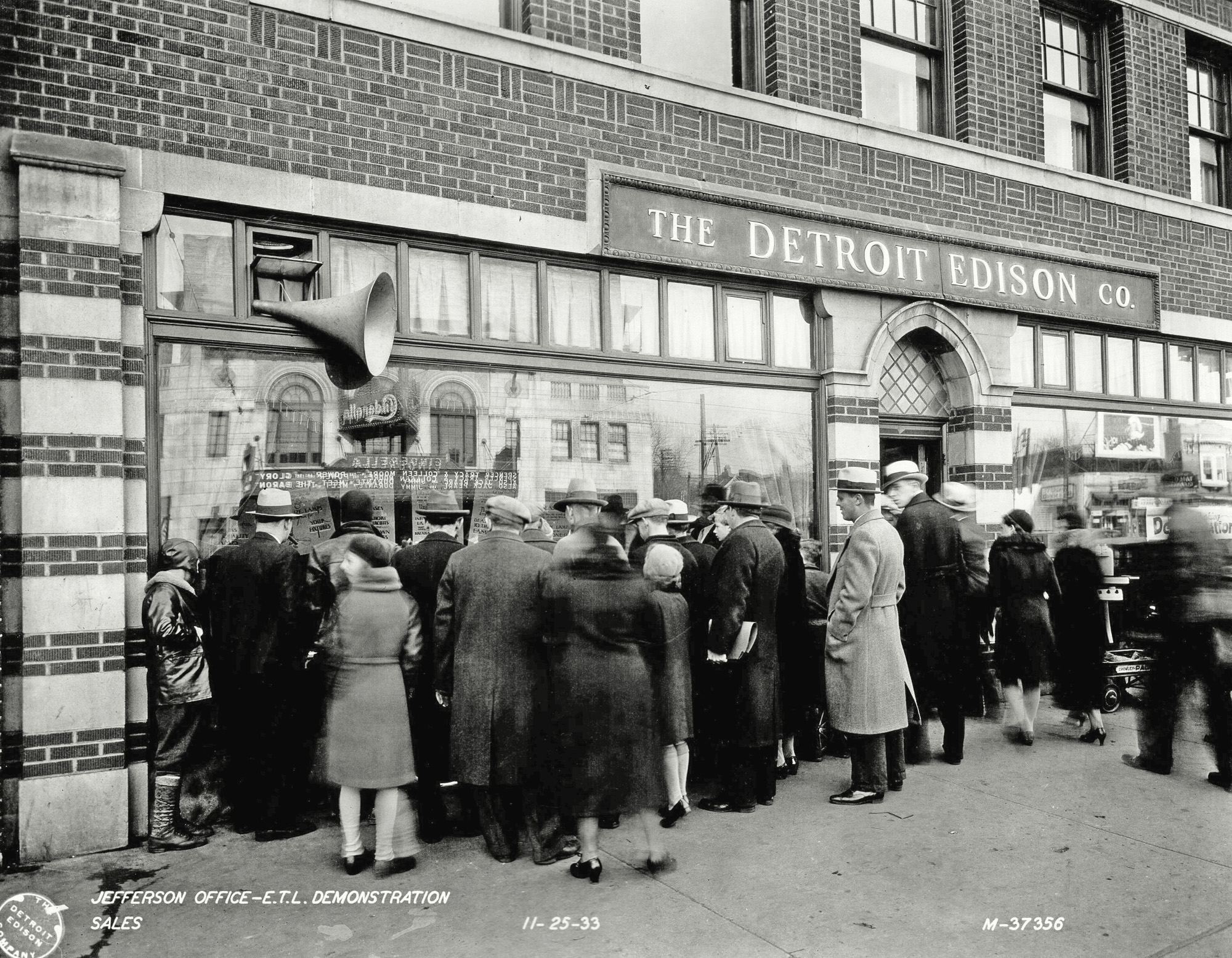 The Detroit Edison Company, Jefferson Sales Office demonstration, November 11, 1933. Reflection in window shows that Spencer Tracy, Colleen Moore, Jack Pearl and Jimmy Durante were staring in a movie across the street. Photo by Detroit Edison Company Photographic Department. View full size.