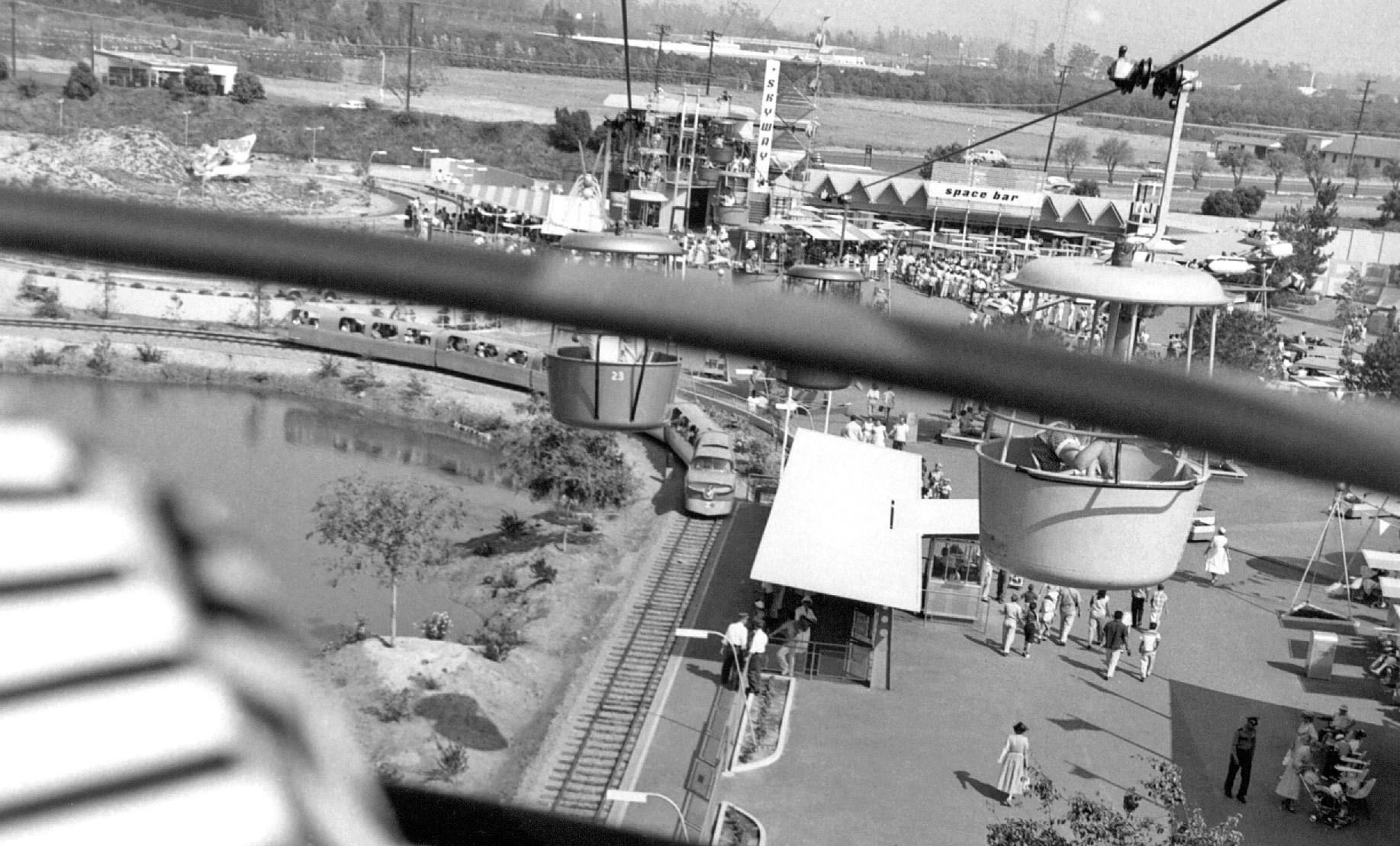 Here's a shot my dad took at Disneyland, summer 1955, from the Skyway. Note the undeveloped orchards in the background, and the 1940's-era car driving along the two-lane blacktop outside of the park. View has changed somewhat since then. View full size.