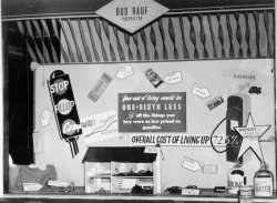 The display board at my grandfather's service station in Delhi (Cincinnati, OH), 1949. View full size.
Illustrating the low price of gasolineWhat an elaborate, interesting display!  It really took some thought and planning to get all the percentages and examples of products.  I love the dollhouse, too.
(ShorpyBlog, Member Gallery)