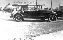 3x5 Photograph found at a thrift Store, mounted on a loose page from a photo album. 
The Gilmore Gas Station in the background was located at Wilshire Blvd and La Brea in Los Angeles.
I think the Car is a Packard.
Ed&#039;s RoadsterI can't find any pictures of Packards or anything else with an exposed gas tank as late as the 1920s, except for a few racing cars. Indeed, that whole trunk/tank arrangement is rather odd looking. I've got a feeling that this is custom coachwork, either in its entirety or at least from the passenger compartment back. Given the location - a couple of miles south of Hollywood and east of Beverly Hills - I'd guess that custom cars were relatively common in that area in the 1920s. Something about the car (the apparent lack of any provision for a top) has to me a very specific Southern California feel to it.
(ShorpyBlog, Member Gallery)