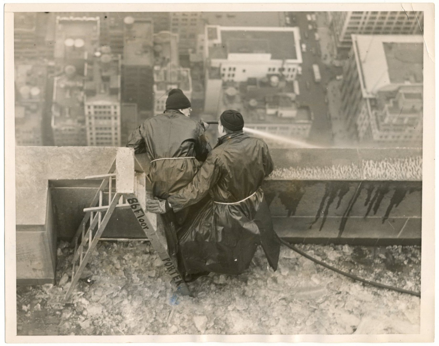 In my collection from years ago. Writing on the back says, "Ice Falling From Empire State Bldg. Two workers clearing ice on the outside of the 86th floor, with warm water." Credit: ACME. March 15, 1940. 