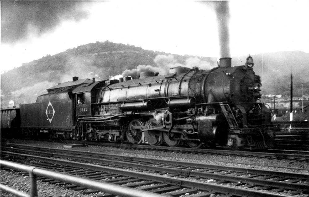 Erie Railroad #3342, Class S Berkshire heading eastbound out of Port Jervis, NY. The Photo looks like the work of a Brownie box camera; nevertheless, it's long on drama.  Thanks to the unknown photographer. View full size.