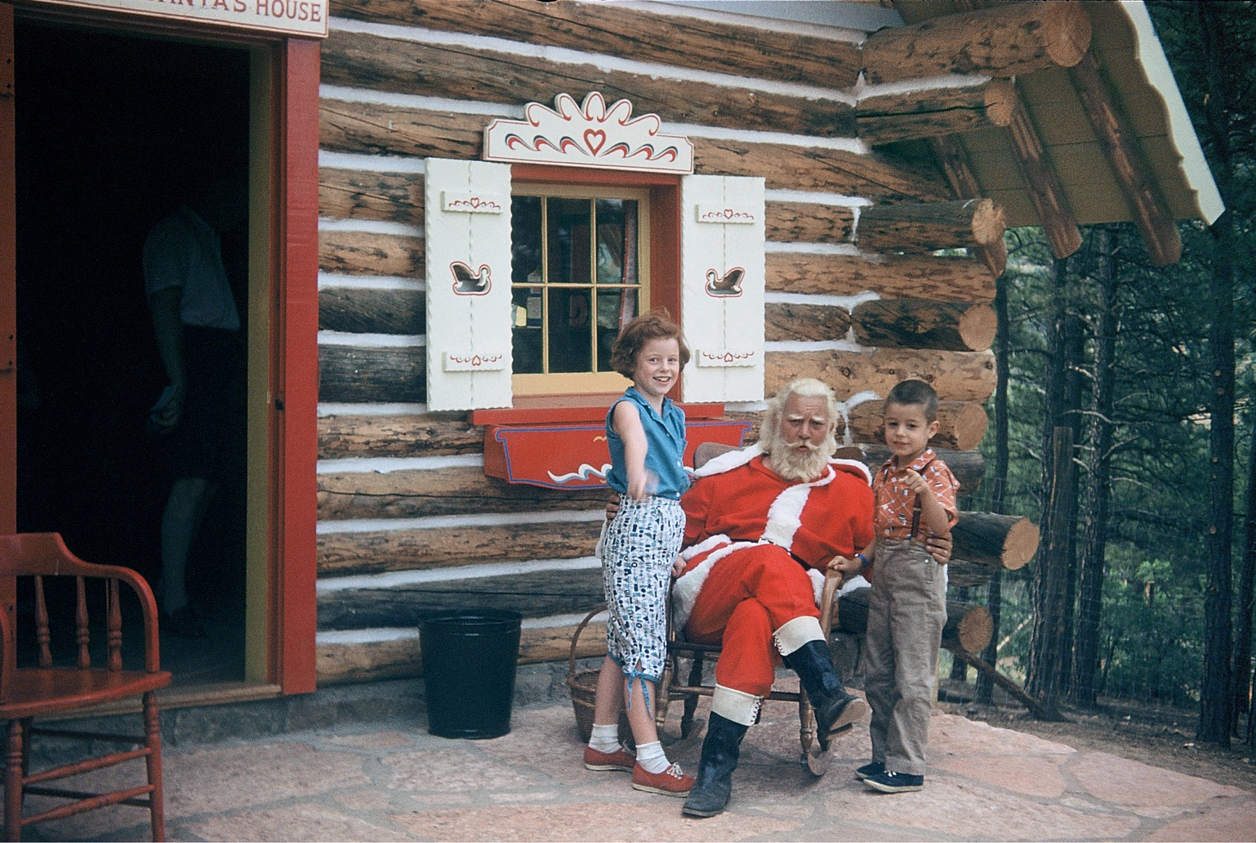 My dad (6 years old) and his older sister in 1956 at "North Pole Colorado -- Home of Santa's Workshop" at the foot of Pike's Peak. Santa sure looks jolly. Full size.