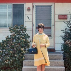 My mother standing in front of our house in Massapequa, Long Island, in 1971. In six months I would be born. View full size.
MassapequaLove this picture. I grew up in Massapequa around the same time (b. 1959). It's great to see a picture that, even though it is of a stranger, looks so familiar.  
World wide fashionI was born in 1970, thousands of miles away from Massapequa - in Israel, which actually was still quite a spartan society back then. Buy if I could find a decent slide depicting my mother at that time, I promise it would be a spitting image: same beehive hairdo, same dress, same wool coat, same purse. Just amazing.
All AmericanWe moved to Massapequa Park in 1972 when I was 4.  What a wonderful place to grow up.
I can relateMy kids were born in 1973 and 1976 and I LOVE the clothes she is wearing!!  Great pic!!!
Oooo!I want her purse! It is so chic and up to the minute.  I am serious--they are back in style!
Siding curiosity The house looks like it has asbestos siding, popular in the late 40's and early to mid 50's. Am I right, wrong? The picture, regardless of the siding is great.
Hey JalousieGreat shot. I'd forgotten those jalousie storm doors. Even more great memories!
My Cousin gjoeFor some reason, I hear Marisa Tomei.
HaberdasheryGreat picture. I love that coat. I couldn't help thinking though, that I have neckties older than you. 
ChicOf course, if the picture were to be taken today, she would be wearing a leotard, maybe something with a bare midriff, as that seems to be the style today.  Oh, for the days of modesty.
Did you knowMassapequa is an Indian word meaning "station wagon"?
You were there honeyI have WW2 pictures of my wife and son and myself taken on the beach at Lompoc, California, and I love to tell my daughter, born September 5, 1946, a true baby boomer, that she was there with us. 
BeautifulI was 9 years old in 1971;  my mother wore the same fashions and the
same hairstyle.  My mother was beautiful;  I never knew how beautiful
until I reached adulthood.  These fashions looked good on this lady and
they looked good on my mother.
My houseI grew up in Garden City South (b 1975), only a few miles away from Massapequa. However, that door, those steps, and that siding looks like a thousand houses on Long Island.
The great LI building boom started in 1939-1940, before Pearl Harbor, back when Grumman and many other smaller aerospace manufacturers were supplying the Allies. Most houses sported the same asbestos shingles until the mid to late 1970s when vinyl siding, most of the time, was installed right over it.
Joe from LI NY
Re: ChicSorry Marcus, leotards and bare midriffs are very much not in style now! Today, she would be wearing something similar, the clothing only slightly updated, looking absolutely tre chic and the envy of vintage inspired fashion lovers everywhere! 
You Bet Your Sweet BippyIf she were standing in front of a psychedelic wall, she could easily be mistaken for JoAnne Worley.
Simply DivineHow could that sunny yellow coat not make you happy?  I wish I could see more of her dress because the print looks wonderful.
Re: Did you knowMassapequa is actually an Indian word meaning "near the mall."
Coast to Coast..I believe that we now have the East Coast counterpart to our beloved TTerrace.
Excellent photo, GJoe.  I remember both my sisters having the same hairdo about that time.  Ah, for the days of yore...
Fellow PequanWhere in Massapequa was this house? I grew up on Division Avenue. Born in '62.
ResponseIt was a 444 N. Syracuse Ave....Thank you for all the great responses to this image. I will have to forward this along to my mother... She will truly enjoy it! I apologize for being so lax in catching up.
Joe
Massapequa MomJust as a point of curiosity, was your mom a teacher?  I grew up in Massapequa, and she looks vaguely familiar... just a few years older than me.
(ShorpyBlog, Member Gallery)