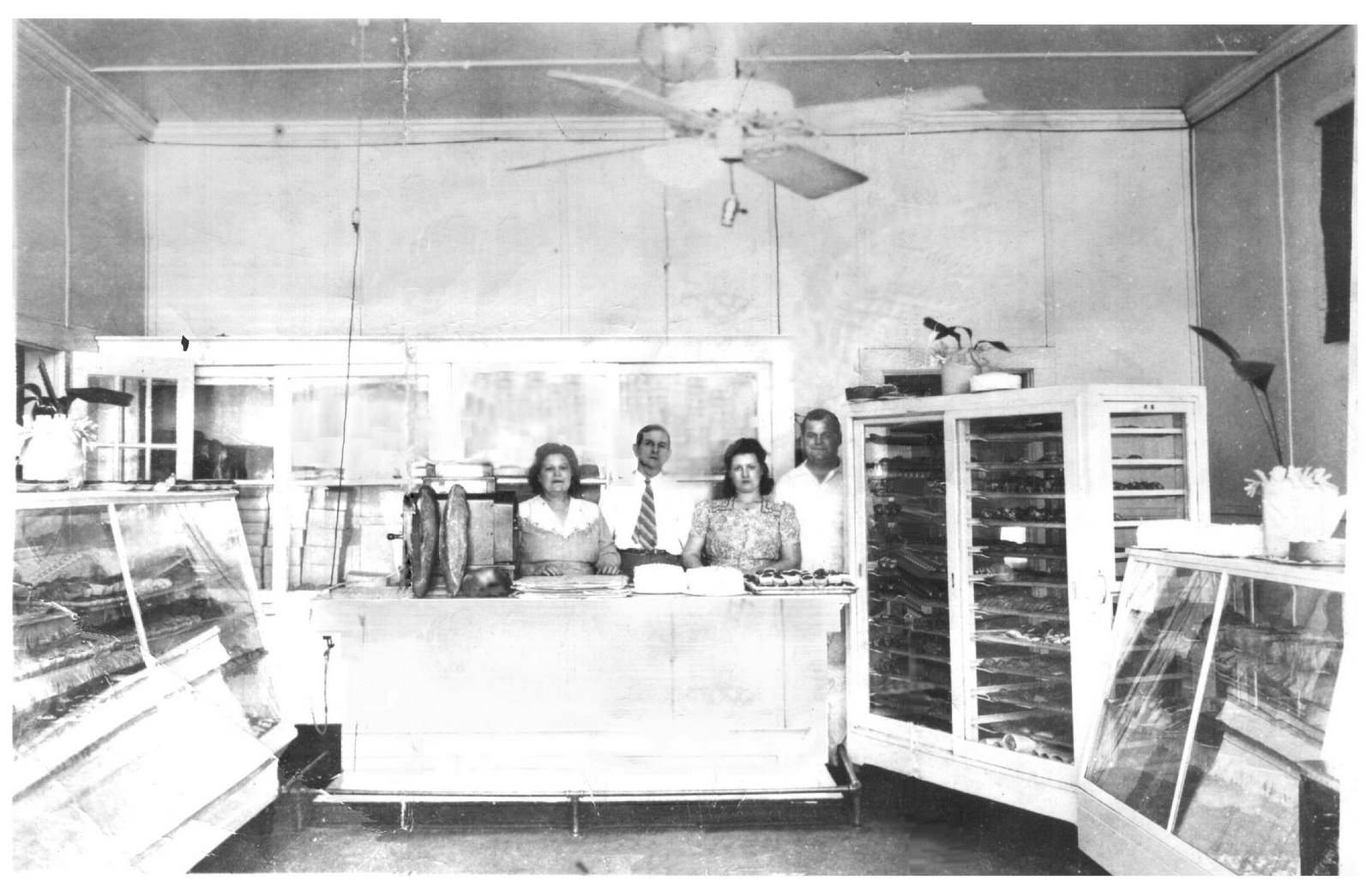 Biloxi, Mississippi - The Biloxi Bakery's retail shop - featuring two standing loaves of Fred Klein Sr.'s Famous French Bread.

Left to right are Feenie, Fred Sr., Verna and Fred Klein Jr.  The shop was remodeled two years later when a restaurant and delicatessen were added on (to the right side of the picture).  