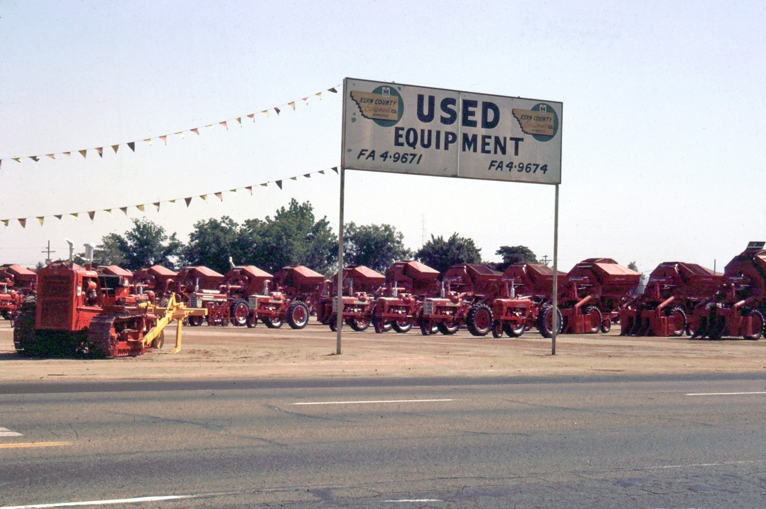 Farm equipment for sale, Bakerfield, CA June 1966. From a Kodachrome slide, found in thrift store 9-14-2012. View full size.